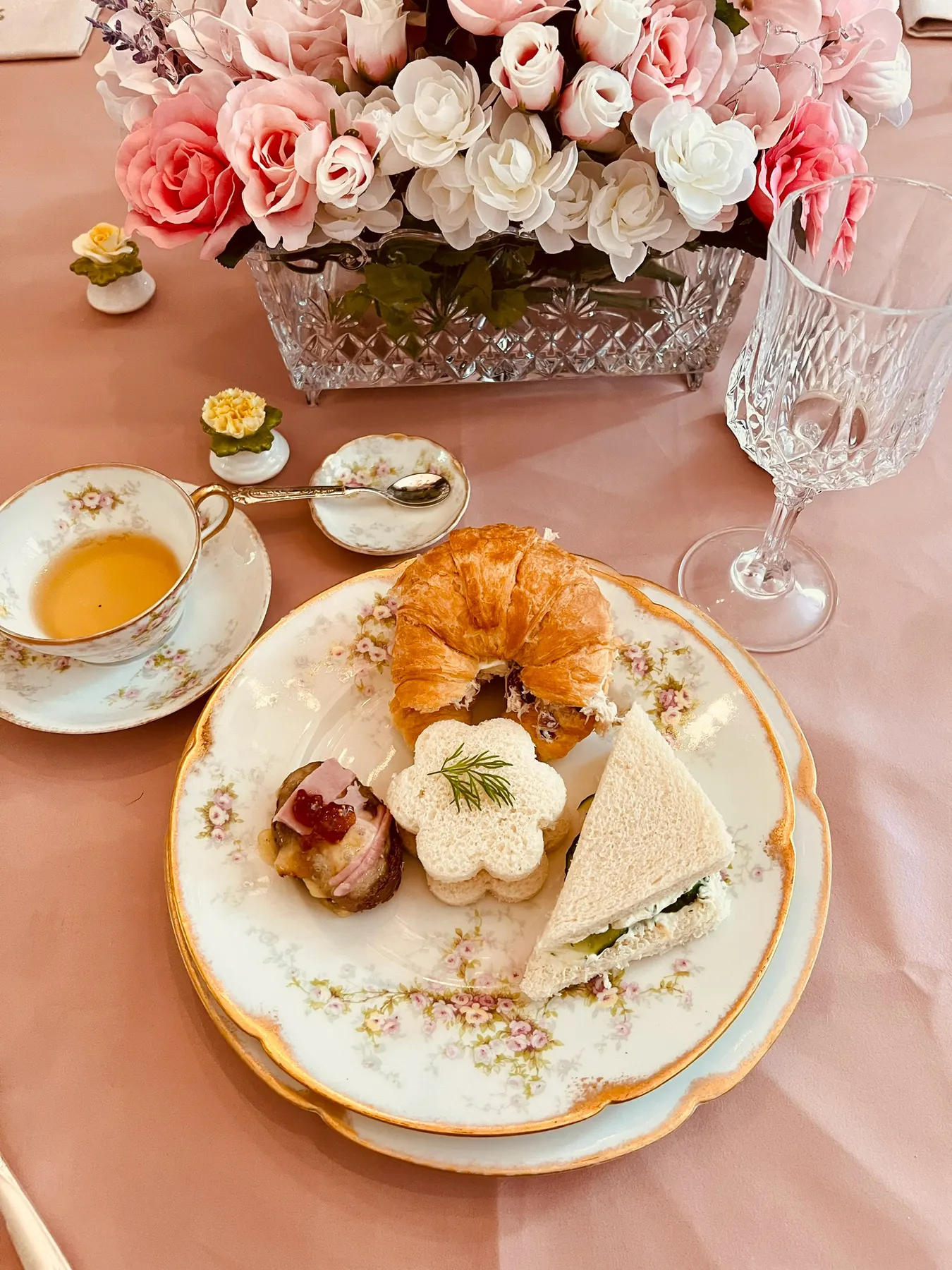 Plated gluten-free pastries, scones and finger sandwiches on vintage floral china